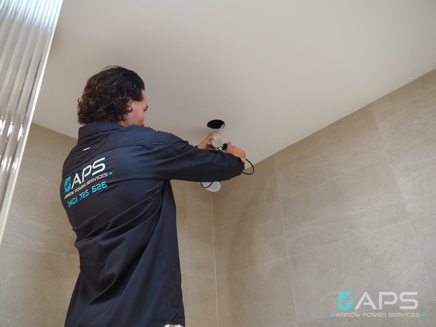 Arrow Power Services electrician installing LED downlights